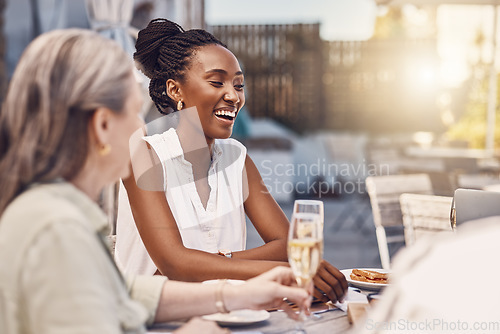 Image of Champagne, celebration and happy women at a restaurant or social event eating at a table with lens flare and fine dining background. Black woman with a smile having food and conversation with friends