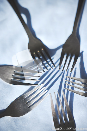 Image of Restaurant service and silver group of fork display on a table for catering service or food industry. Top zoom view of clean, metal or steel cutlery, kitchenware and kitchen tableware equipment