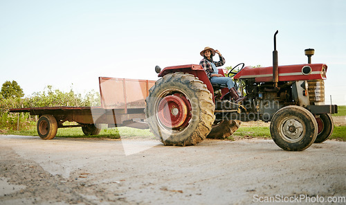 Image of Farm, tractor and agriculture with happy woman farmer driving a vehicle on farm for sustainability, growth and development in a sustainable and green environment. Farming crops in the harvest season