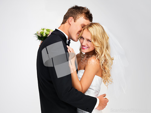 Image of Wedding, couple and marriage with a bride and groom as a couple in studio against a white background. Dress, suit and flowers with a man and woman getting married at a celebration event or ceremony