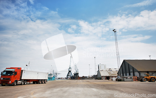 Image of Logistics, supply chain or shipping with a factory, warehouse or plant in the background of a harbor and a truck and crane on the dock. Delivery, cargo and transport in the export and import industry