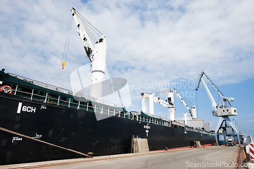 Image of Shipping, logistics and supply chain with a ship in a harbor for freight and cargo delivery. Shipment, courier and service with a commercial and industrial vessel in the export and transport industry