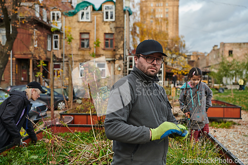 Image of A modern family parents and children, is working together to beautify their front yard with flowers in preparation for the upcoming holiday season.