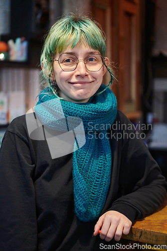 Image of A modern and intriguing girl with striking blue hair enjoys a night out in a cafe transformed into a passionate Halloween-style setting, exuding a captivating and witchy ambiance