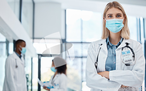 Image of Doctor, healthcare worker and medical professional with covid mask to protect from virus risk working in hospital. Portrait of an expert, proud and face of nurse in medicine career for service
