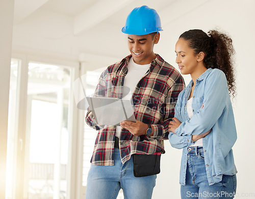 Image of Couple planning home renovation job together, construction worker working with woman on maintenance and remodeling of apartment. Contractor and builder helping with interior design of family home