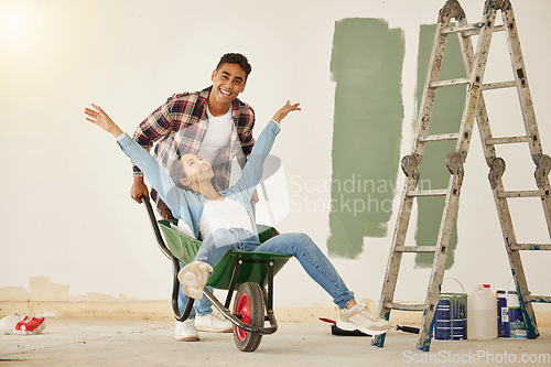 Image of Love, teamwork and renovation, couple paint a wall in a house green. Happy, creative and playful, new home owners do repair work on home. Wheelbarrow, ladder and painting, man and woman have diy fun