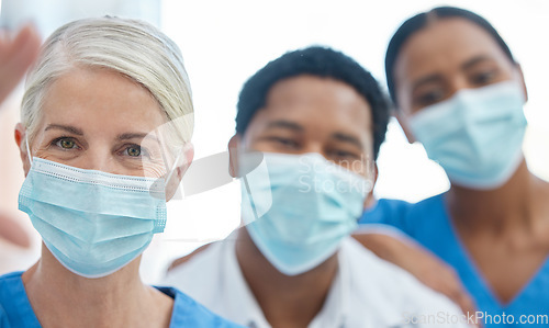 Image of Team selfie of doctors with mask for safety against covid, corona pandemic, or virus in a hospital. Portrait of healthcare employee or medical workers together for support, teamwork and collaboration