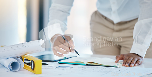 Image of Architect, writing and planning with a business man drawing in a notebook with a blueprint and plan on a table in his office. Construction, engineer and architecture with a creative design at work