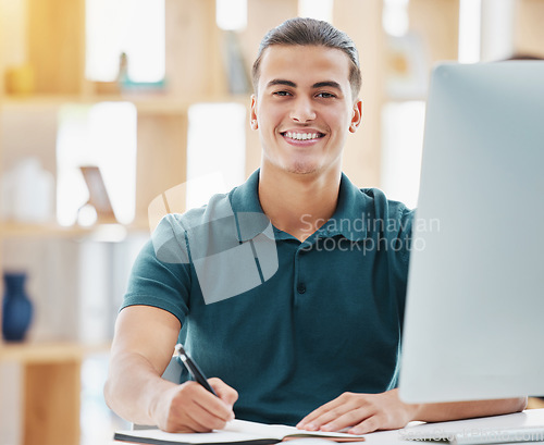 Image of Planning, vision and motivation with business man writing notes in a book while working on a computer in a corporate office. Inspired employee on mission, researching upskill course, being proactive