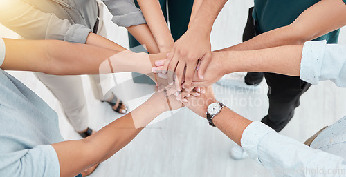 Image of Teamwork, collaboration and motivation business people hands stacked together in office with lens flare. Group hand for goal, community together for team project or company growth mission and trust
