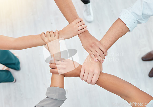 Image of Hope, partnership and support group holding each other at community therapy session. Top view of people doing motivation, love and trust exercise while building a connection at mental health clinic.