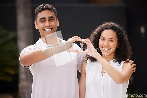 Image of Happy couple buy real estate with key and heart hand sign and a smile together. Man and woman with keys or happiness with property rent or purchase of house, family home or apartment with love