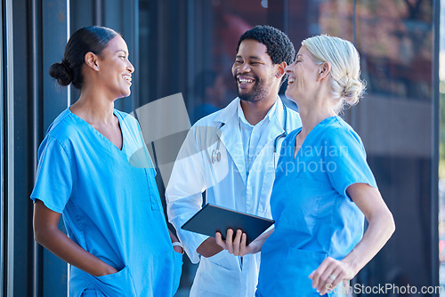 Image of Diversity, teamwork and healthcare, a team of doctors talking and laughing outside a hospital. A happy black doctor and women nurses having a conversation. A group of medical employees during a break