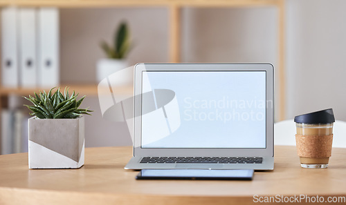 Image of Mockup laptop, coffee and tablet on desk at home office of freelance SEO, UX or digital social media marketing and advertising freelancer. Internet or online work from home remote workspace