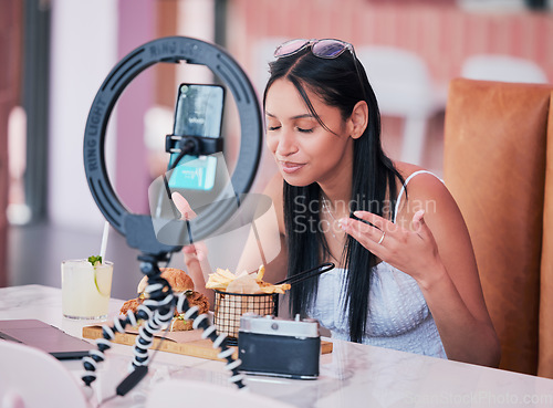 Image of Social media influencer, smartphone and ring light for new fast food restaurant test for internet, web and followers. Creative online communication with digital mobile tech for startup video blog