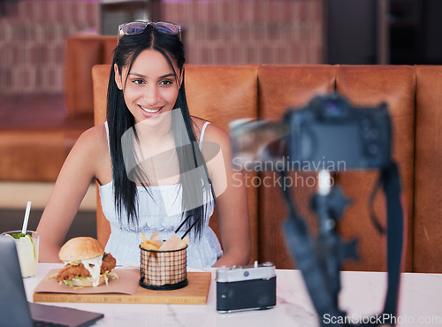 Image of Food influencer, internet speaker at restaurant with camera and recording cooking review social media video. Digital cuisine web content creator or brand ambassador live streaming to online audience.