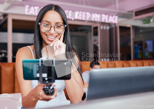 Image of Social media influencer and phone with a woman recording content and live streaming subscription service for subscribers. Podcast, blog and video upload with a young female creator at a coffee shop