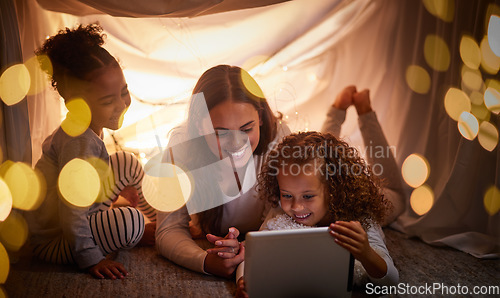 Image of Mother, children and tablet with happy family watching online tv, learning with education games and reading ebook at night at home. Internet and enjoying live stream movies with cartoon subscription