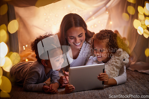 Image of Mother and children live streaming movies on tablet or digital kids app in a tent camping at night and bokeh lights. Care, love mom reading ebook to happy girl or online games with home wifi in dark