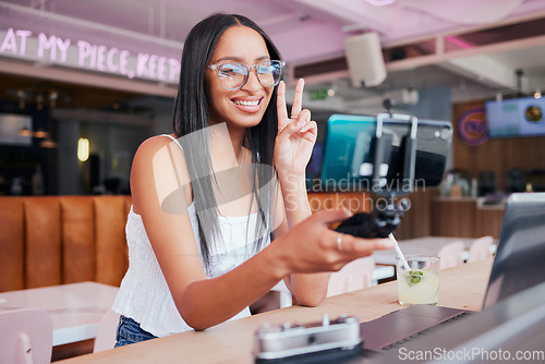 Image of Social media influencer, phone and selfie stick for internet, web and followers with peace sign. Creative online communication with digital mobile tech for startup travel video blog website or app