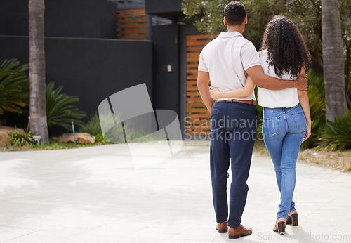 Image of Property, real estate and new home with a man and woman homeowner looking at their house together outside. Property, real estate and an investment in their future with a couple standing on a driveway