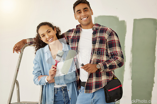 Image of Painting, love and home with a couple doing DIY, renovation and house remodel with a paintbrush and roller. Domestic relationship and teamwork with a man and woman ready to paint a room