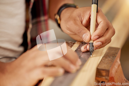 Image of Working handyman, carpenter and building construction worker with wood for a maintenance job. Builder or contractor hands doing measure work for a home improvement project with tools at a workshop