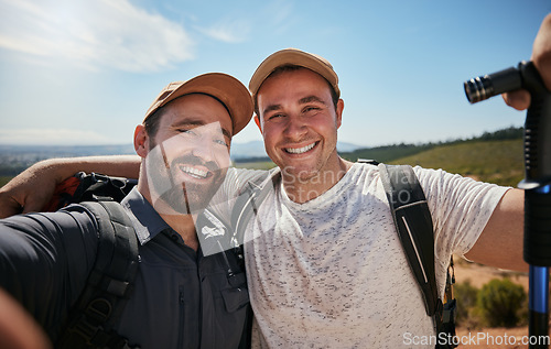 Image of Friends, brothers or hikers taking a selfie while hiking outdoors in nature sharing the experience on social media. Active, fit and athletic men take a picture or a photo while trekking