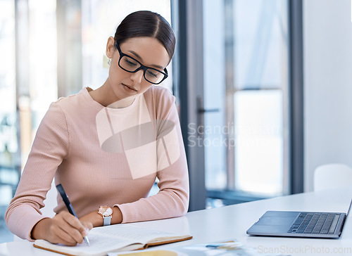 Image of Planning, thinking and strategy with business woman writing notes while working on a laptop in a corporate office. Professional assistant plan schedule and meetings, using journal to write reminder