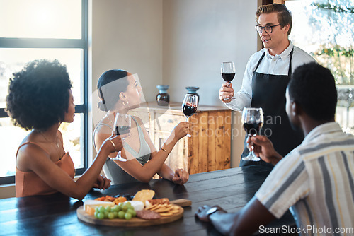 Image of Wine tasting with friends and professional waiter explain the blend and flavor of red wine. Couple enjoying a drink, learning about wine making process at a restaurant with happy winemaker