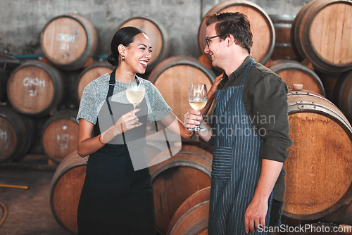 Image of Winemaker business partners having fun talking at winery, white wine tasting and laugh. Young sommelier testing flavor and alcohol drink blend, bonding in cellar, celebrating good quality Chardonnay