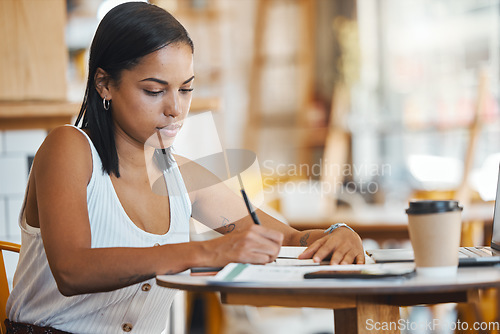 Image of Small business owner, startup entrepreneur or cafe store manager writing notes, working on strategy or planning in a coffee shop. Professional, finance and budget businesswoman filling out papers.