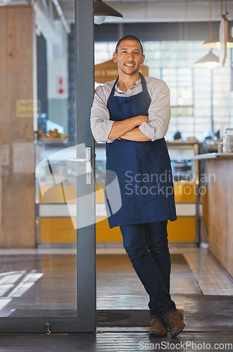 Image of Entrepreneur of cafe or coffee shop, small business and male owner of a modern startup restaurant. Businessman with motivation, manager and leadership skills standing at the door to welcome customers
