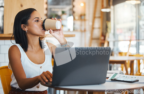 Image of Entrepreneur drinking tea while working on laptop at cafe, woman reading emails online and person enjoying a remote work space at a restaurant. Thinking female browsing the internet at coffee shop