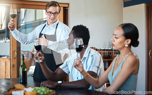 Image of Wine tasting with black couple and professional sommelier explaining the blend and flavor of red wine. Couple enjoying a drink, learning about wine making process at a restaurant with happy winemaker