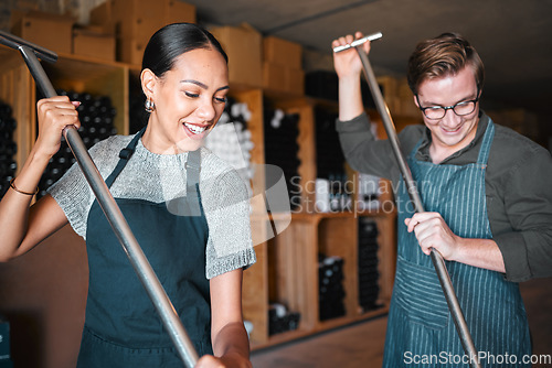 Image of Winemaker workers in wine production using press tool for mixing or pressing in a warehouse, winery or distillery. Teamwork people, woman and man working on quality alcohol, manual labor in a cellar