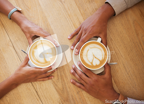 Image of Creative latte art, cappuccino and coffee drink in cafe with couple and friends enjoying cup of java with milk froth together. Closeup of people hands from above meeting and drinking in restaurant