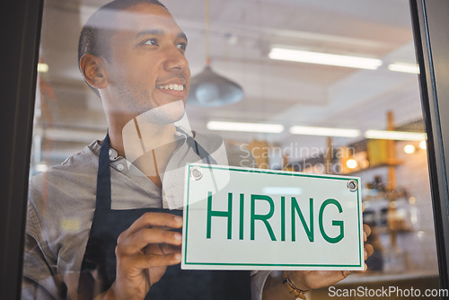 Image of Recruitment, advertising and small business owner with hiring sign board on window or door of cafe or restaurant, happy and positive. Young business man excited open after end of covid virus pandemic