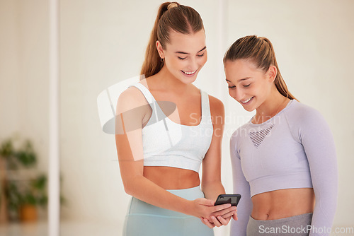Image of Fit, happy and athletic women laughing at funny social media posts on a phone before exercising together. Young athletes or workout friends browsing online or the internet and having fun
