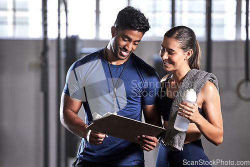 Image of Gym subscription, personal trainer and happy client talking and ready to fill in a membership form. Fitness coach discussing training, workout plan and progress in a health and wellness facility