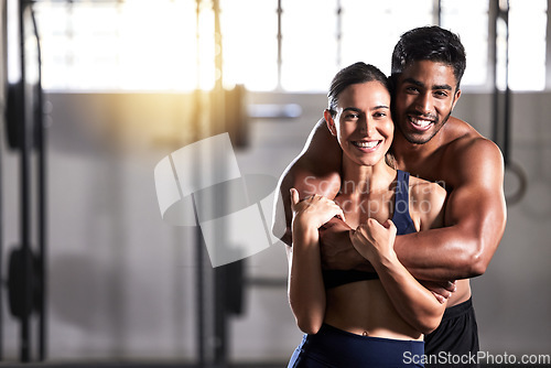 Image of Strong, active and wellness couple looking fit and healthy after workout training session in a gym. Young sexy, attractive and athletic boyfriend and girlfriend hugging after reaching fitness goal