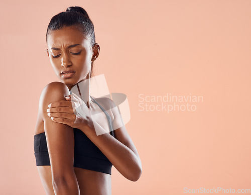 Image of Life insurance for fitness trainer with sports injury in activewear on world health day on paper background. Worried girl exercising in gym has painful arm muscle, concerned about self care wellness.