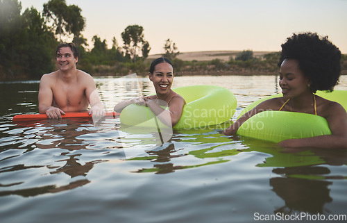 Image of Fun group of diverse friends relaxing in lake water, enjoying nature and bonding on a getaway vacation in the countryside together. Happy men and women laughing, smile and looking relaxed on holiday