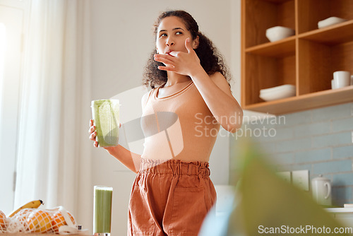 Image of Eating, tasting and drinking a green health smoothie with a young female in a kitchen. Woman on a weight loss, organic and fresh fruit and food diet for wellness, nutrition and a healthy lifestyle
