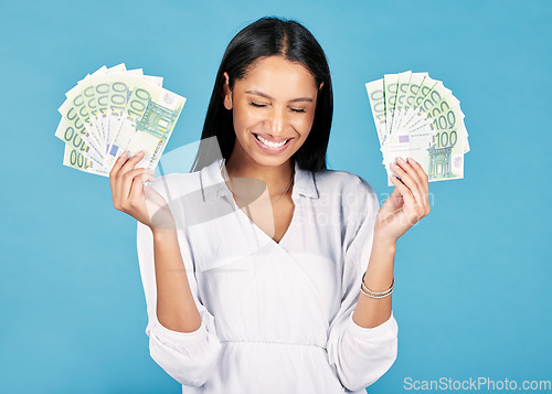 Image of Money, winner and cash in hands of a woman cheering wealth and success in celebration with a wow in studio on blue background. Rich, celebrating and excitement with a happy female winning the lottery