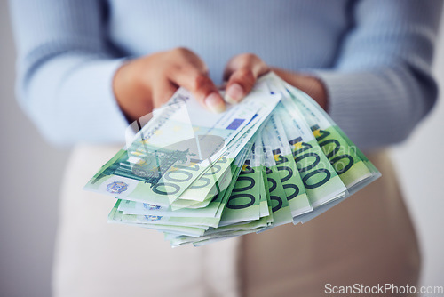 Image of Finance, bonus and investment hand holding money, cash or bank notes for savings, wealth or spending closeup. Woman with lots of bills, financial growth or profit used for large purchase or payment