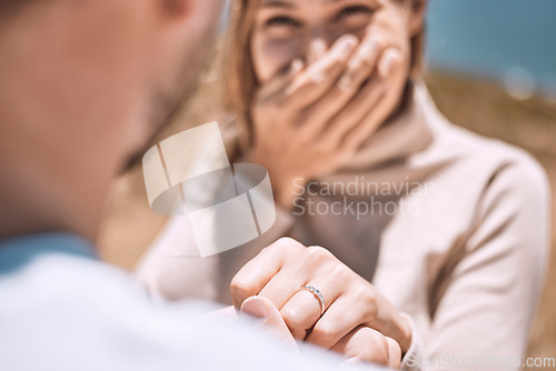 Image of Engagement, proposal and romance wth a man asking his fiance to marry him while dating and spending time together. Closeup of a ring on the finger of a woman who just say yes to a marriage proposing