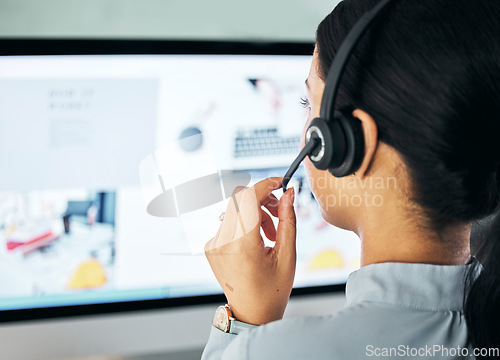 Image of Call center agent giving online support with computer screen, working as advisor and doing telemarketing in an office at work from behind. Closeup of customer service representative talking with pc