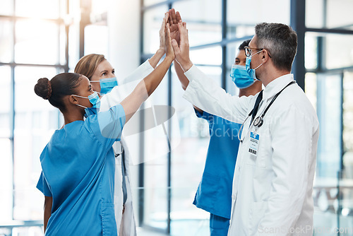 Image of Covid doctors and nurses high five for teamwork success, collaboration and support in a hospital. Medical and healthcare professionals motivation, unity and community ready to work together as a team